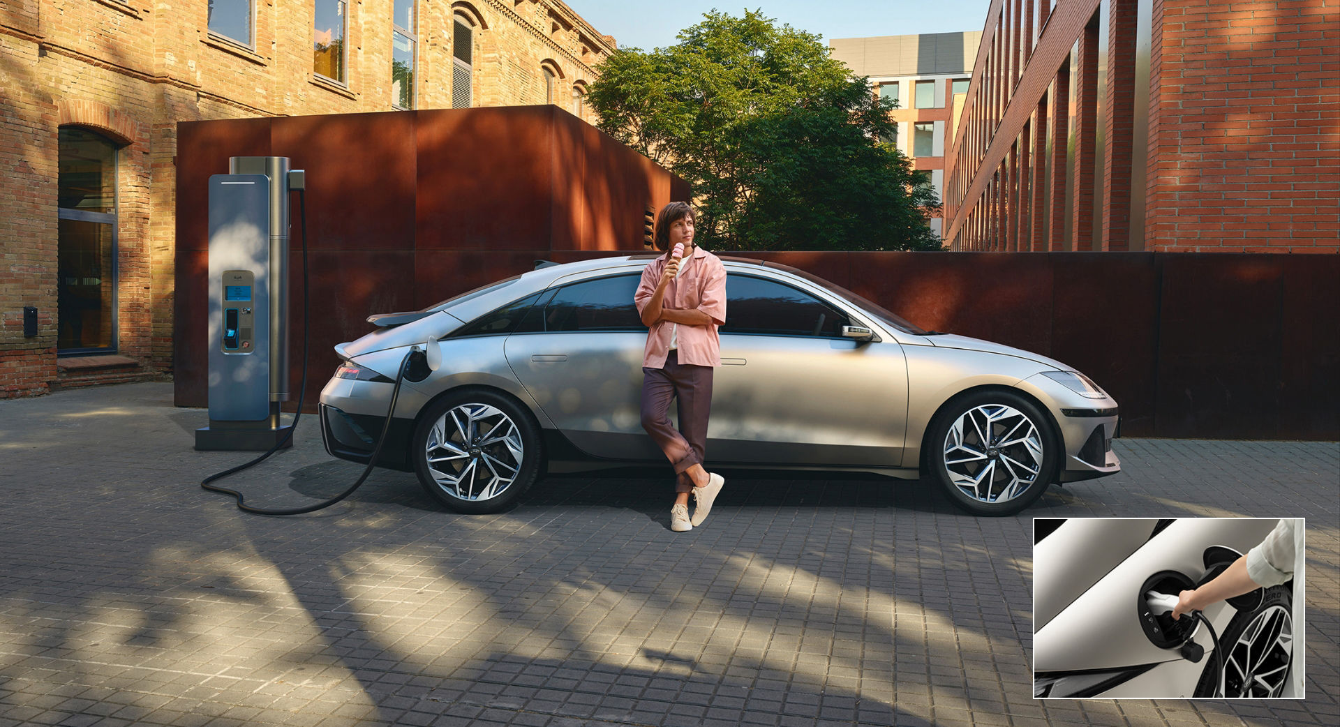 ioniq6 man leaning on charging ioniq6 pc